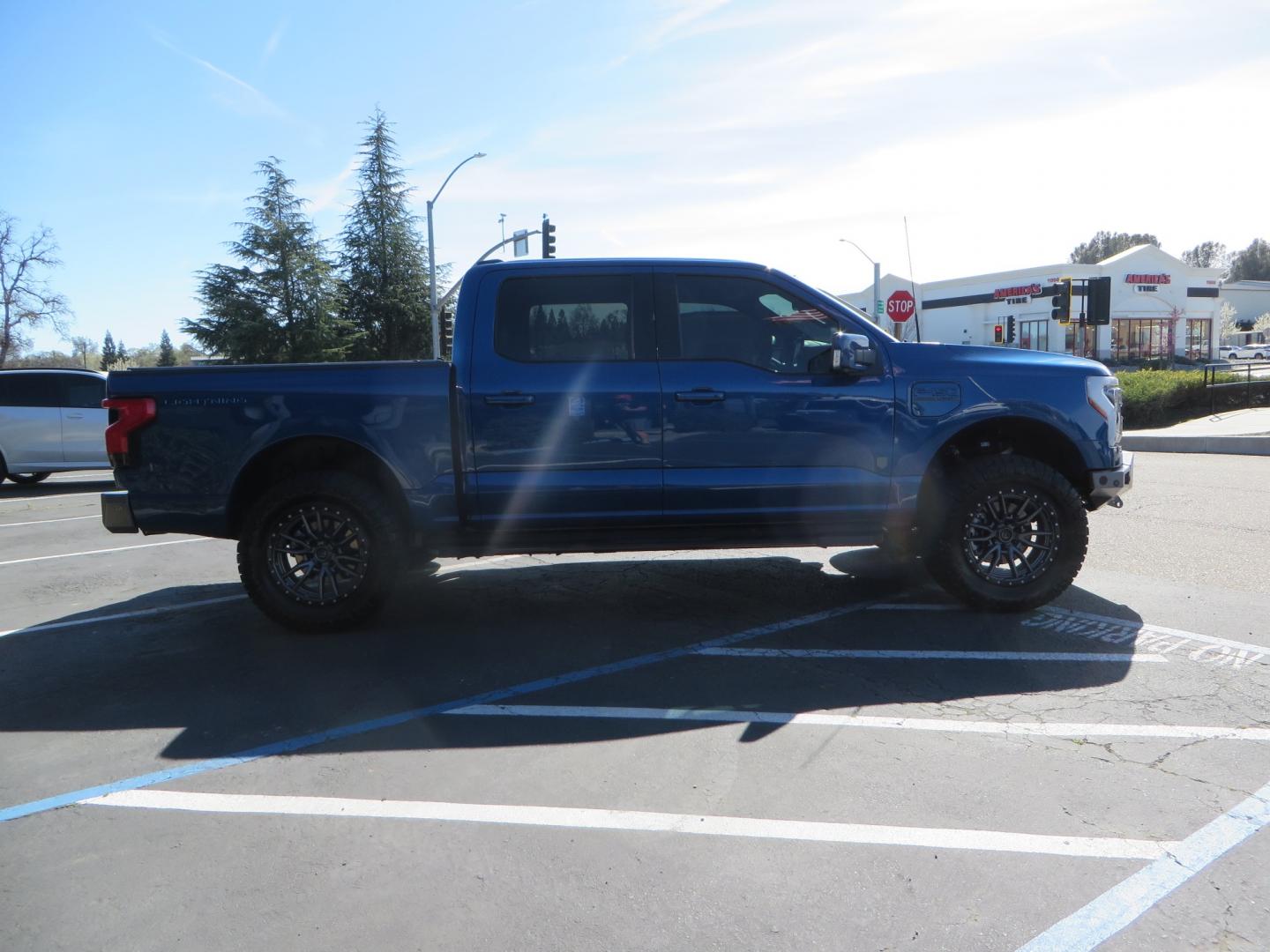 2022 BLUE /BLACK Ford F-150 Lariat Crew Cab 4WD (1FT6W1EV6NW) , located at 2630 Grass Valley Highway, Auburn, CA, 95603, (530) 508-5100, 38.937893, -121.095482 - Tired of gas prices and still want to look cool? Check out this Ford Lightning featuring a RC level kit, Nitto Ridge Grappler tires, Fuel Rebel wheels, Sinister front and rear bumpers, Baja Designs leds, Rigid Industries Leds, Bakflip F1, and window tint. - Photo#3